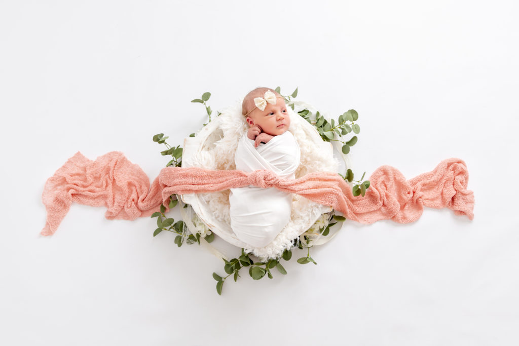 Studio Newborn Photo of a newborn girl wrapped in a swaddle